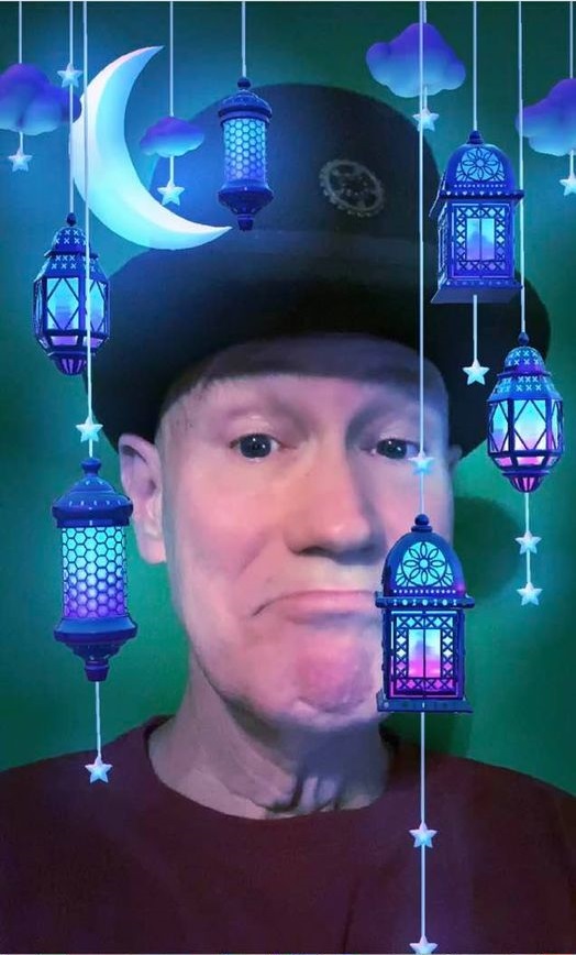 James Carvin wearing a Pamalogy top hat surrounded by lanterns and moonlight.
